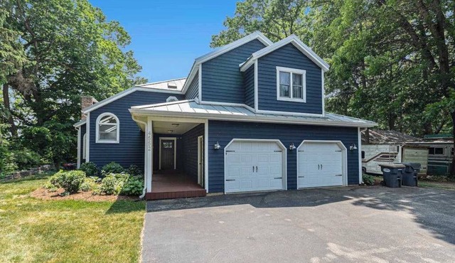 Serene lakefront retreat with an expansive deck, dock access, game room, & AC in Berrien Springs
